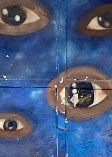 painted eyes on a blue wall
